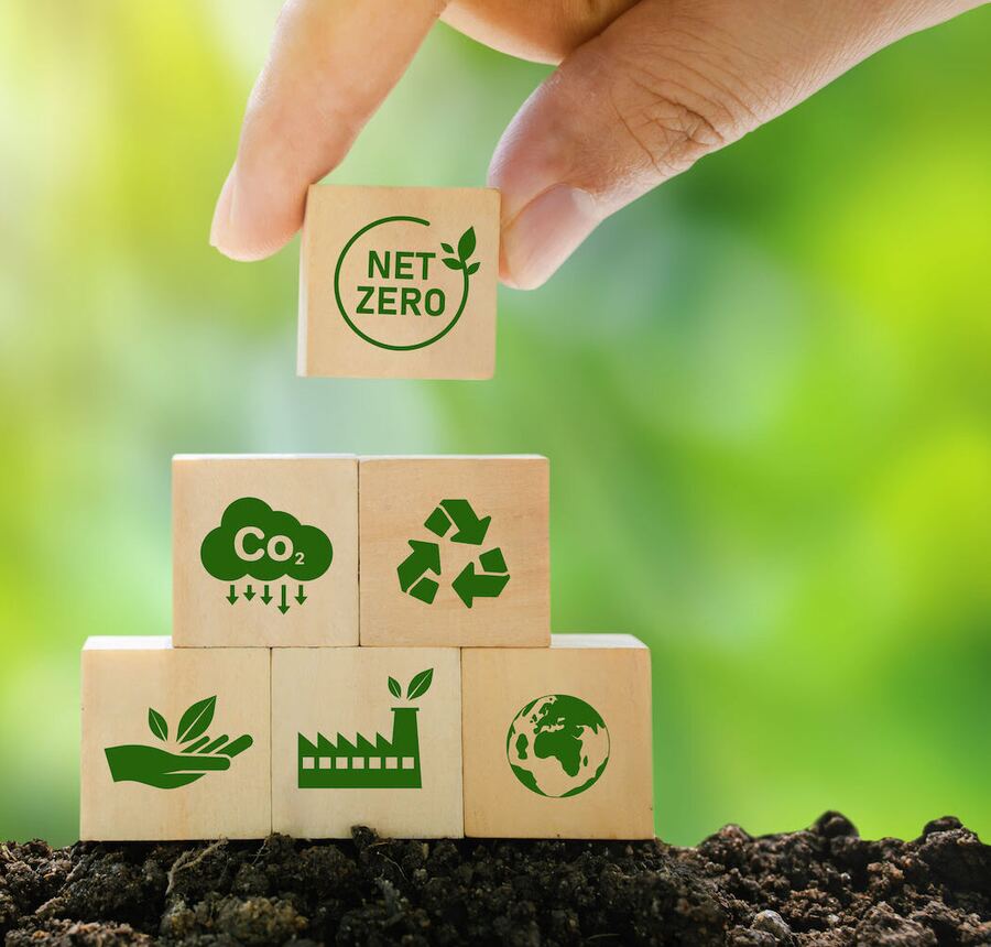Net Zero, CO2 and renewable energy blocks stacked on soil